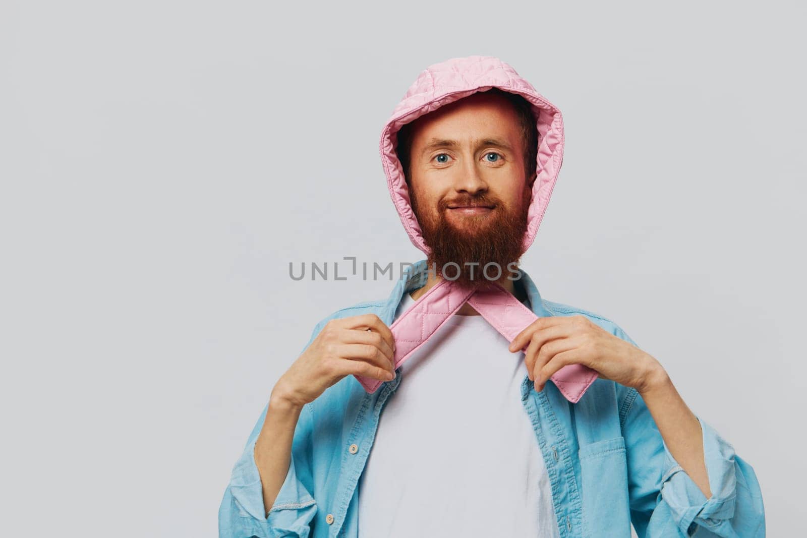 Funny man in a pink hat portrait on a light gray background. Smile and positive emotions. by SHOTPRIME