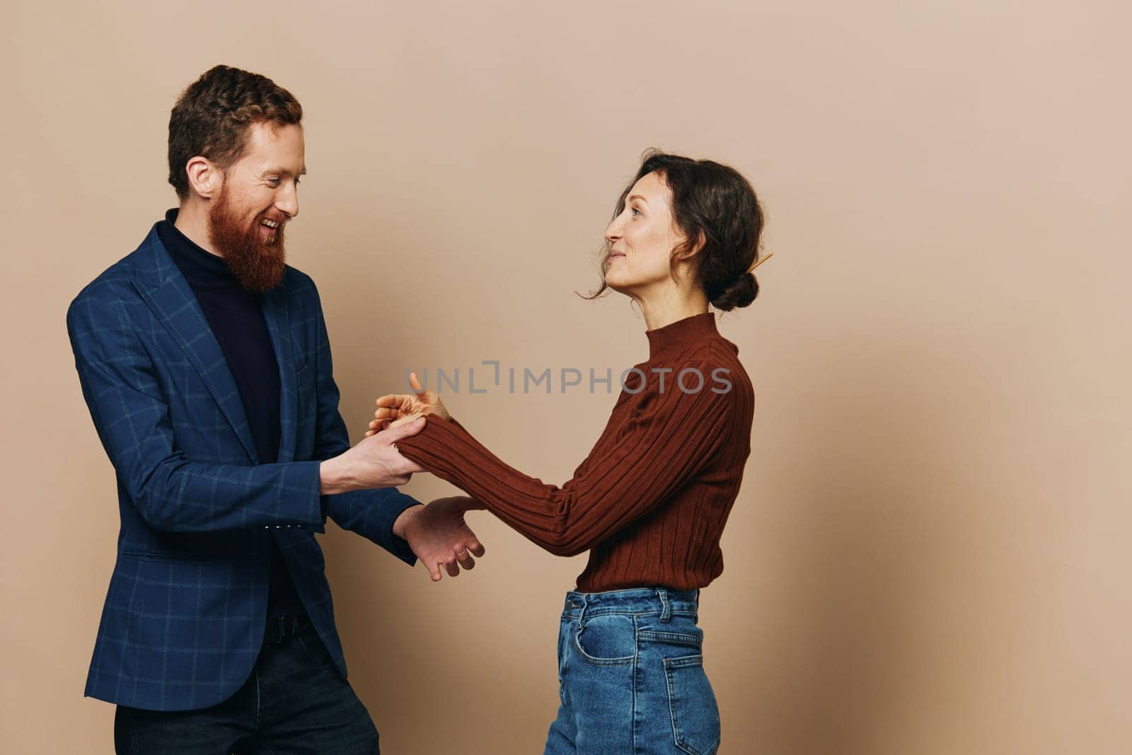 Man and woman couple in a relationship smile and interaction on a beige background in a real relationship between people by SHOTPRIME