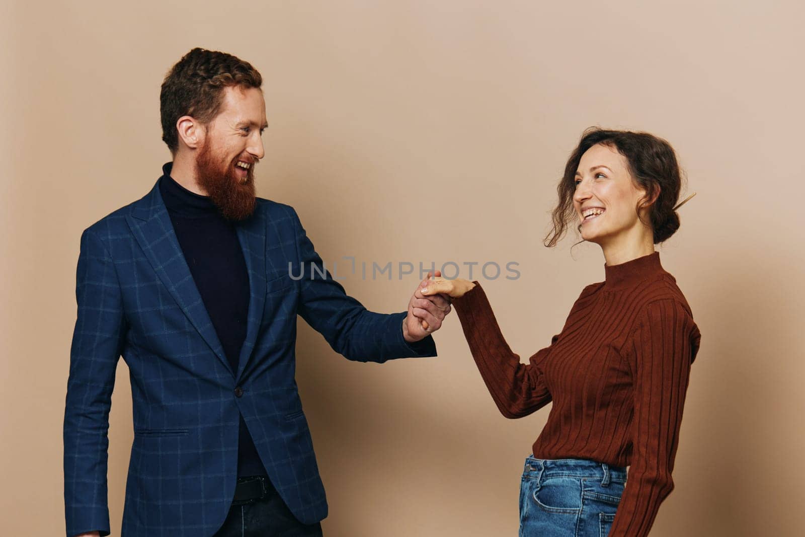 Man and woman couple in a relationship smile and interaction on a beige background in a real relationship between people by SHOTPRIME