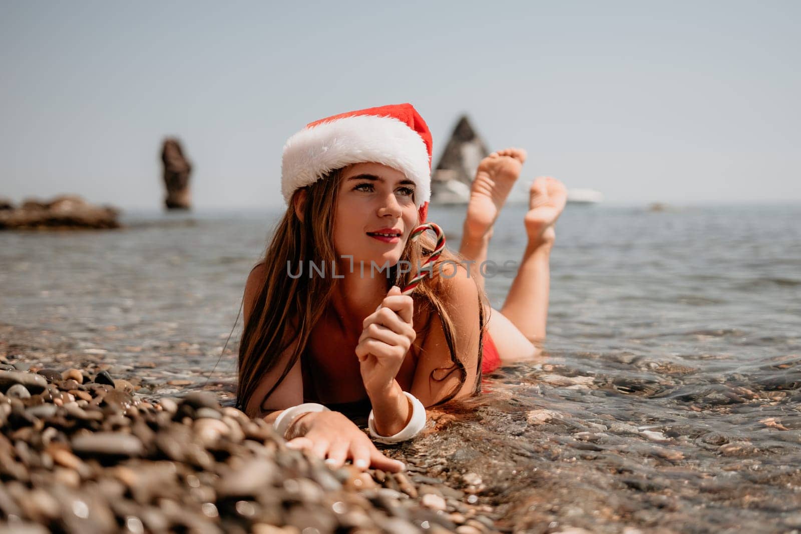 Woman travel sea. Happy tourist taking picture outdoors for memories. Woman traveler looks at the edge of the cliff on the sea bay of mountains, sharing travel adventure journey.