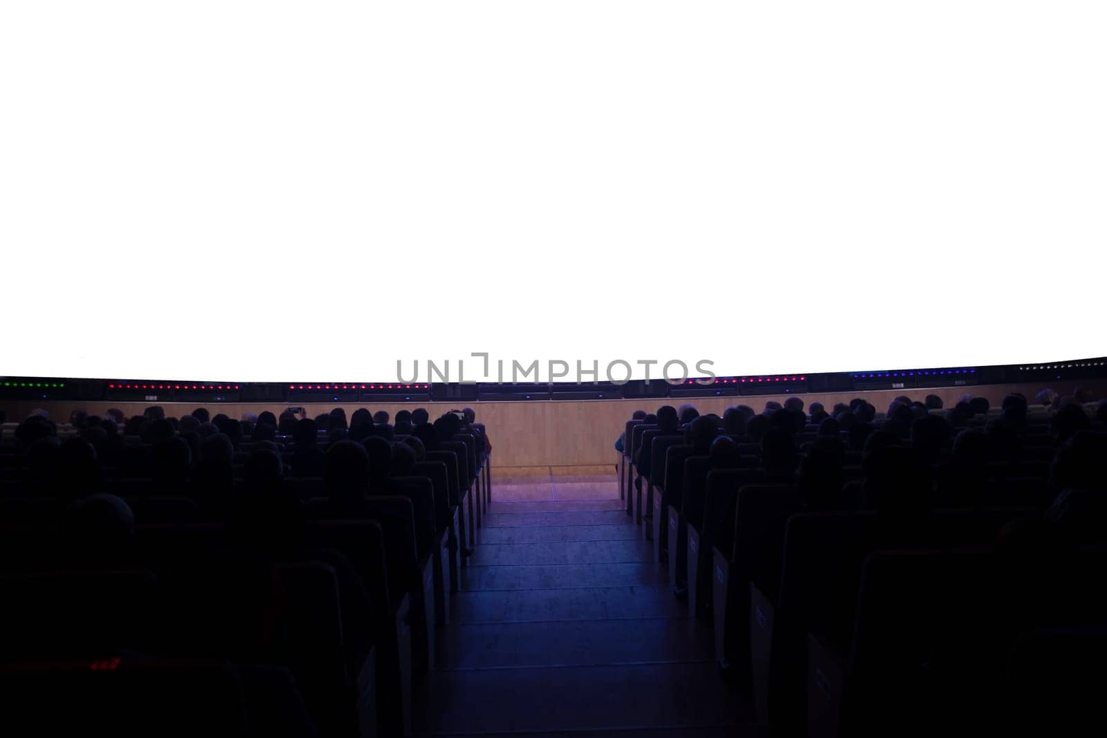 People in the cinema in front of an empty white screen.