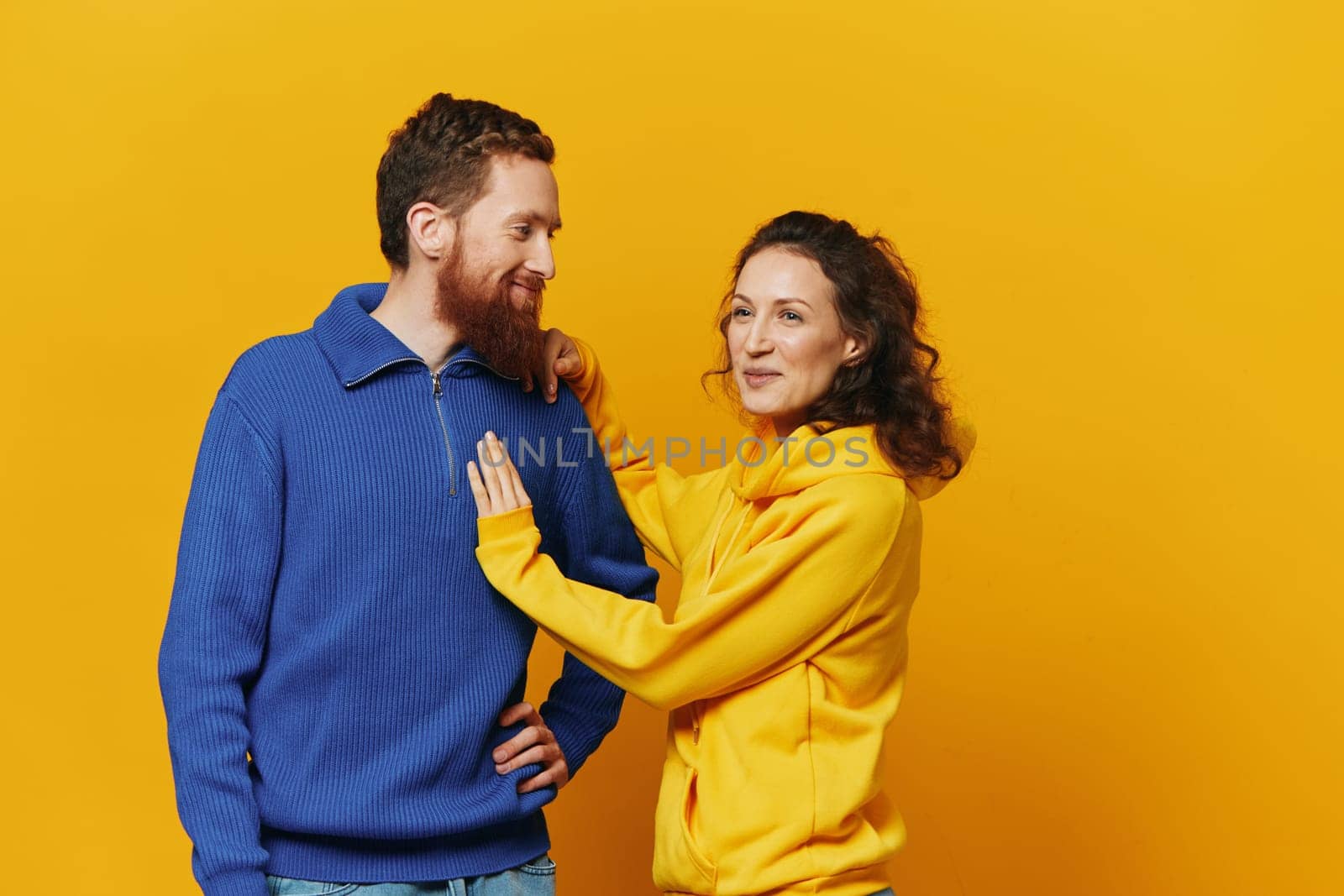 Man and woman couple smile and happiness, yellow background, family . High quality photo