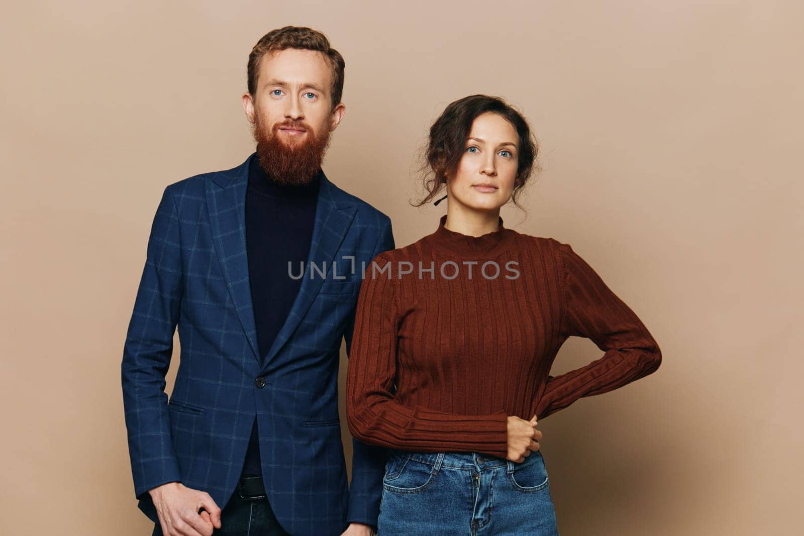 Man and woman couple in a relationship smile and interaction on a beige background in a real relationship between people. High quality photo