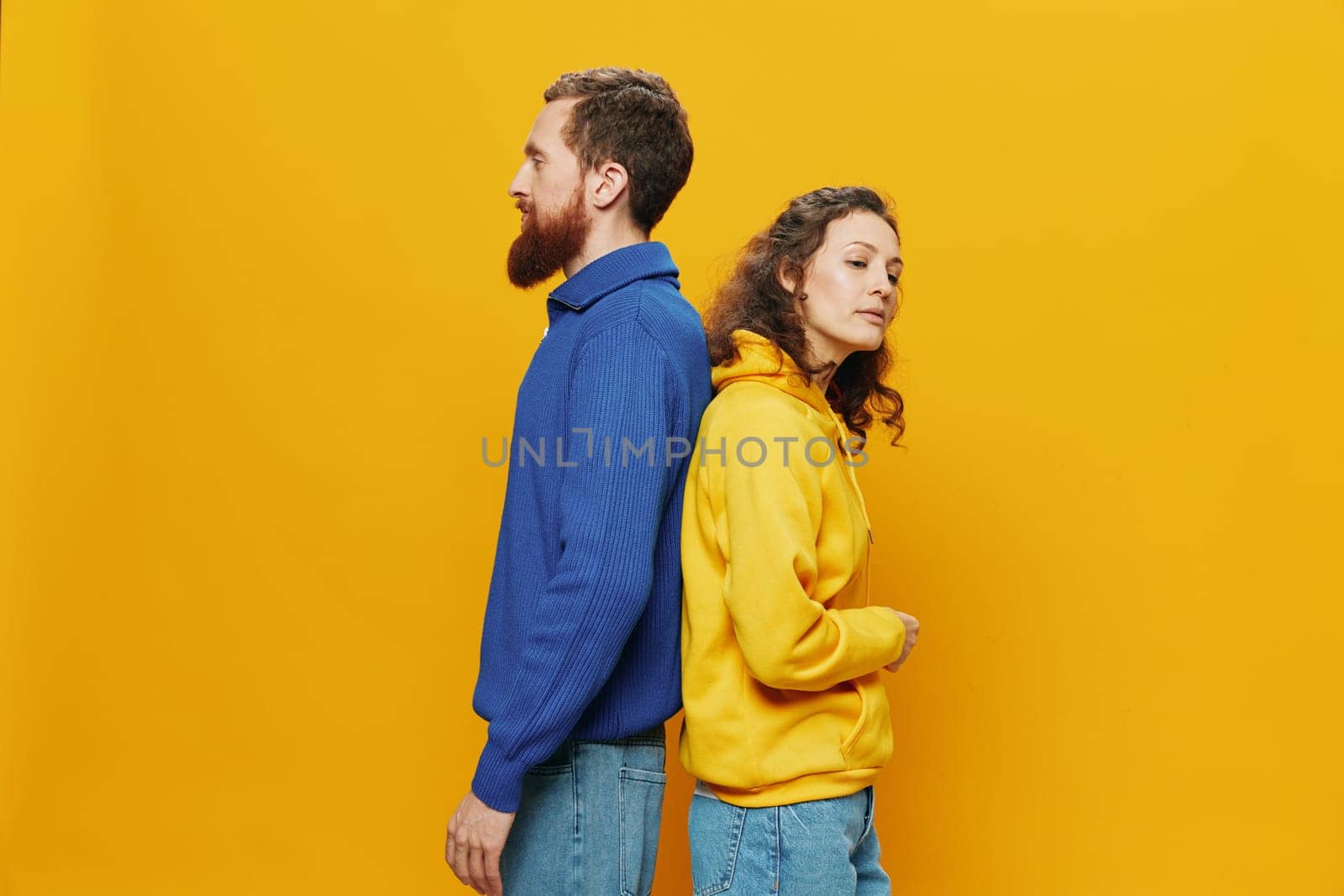 Man and woman couple smiling cheerfully and crooked with glasses, on yellow background, symbols signs and hand gestures, family shoot, newlyweds. High quality photo