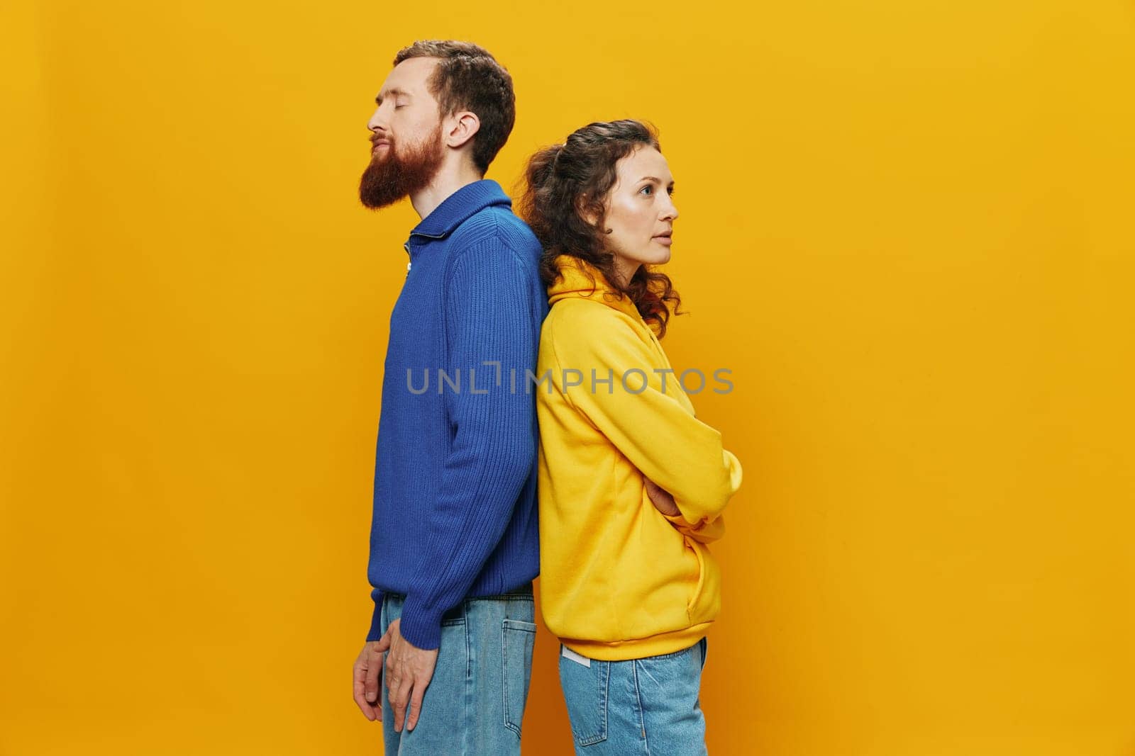 Man and woman couple smiling cheerfully and crooked with glasses, on yellow background, symbols signs and hand gestures, family shoot, newlyweds. High quality photo