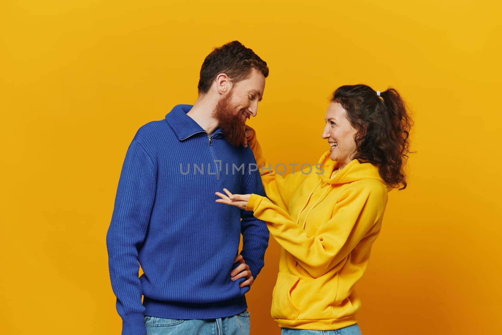 Man and woman couple smile and happiness, yellow background, family . High quality photo