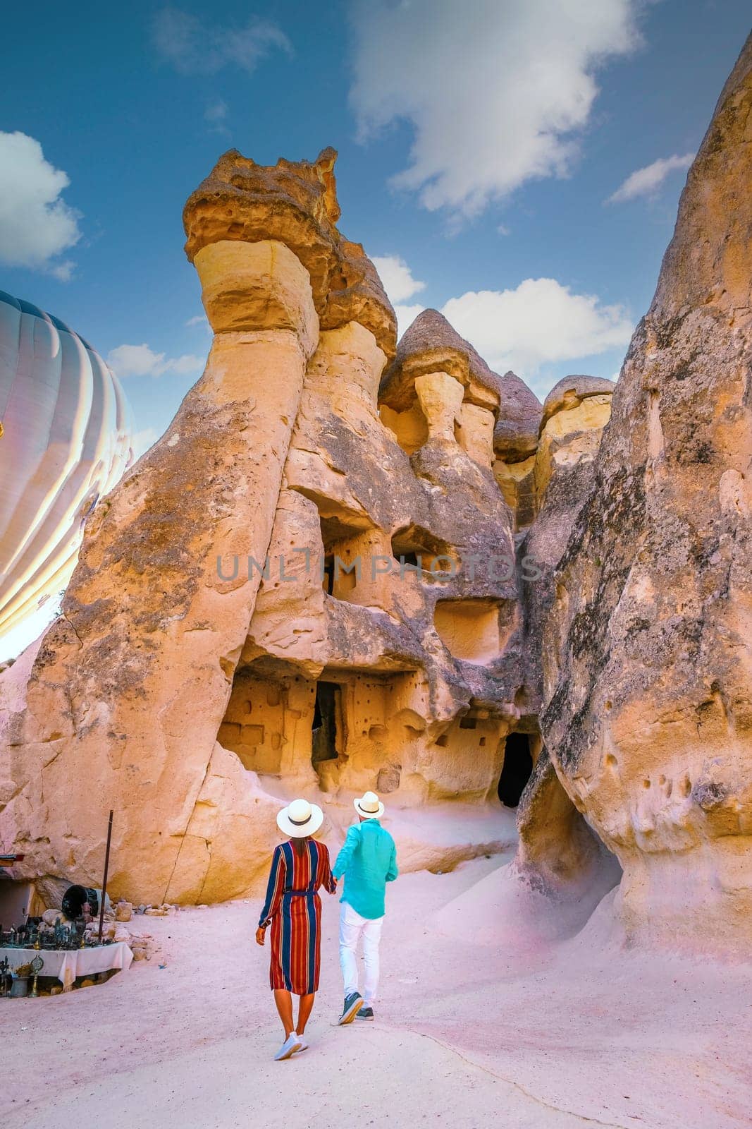 Turkey Cappadocia, a happy young couple of men and women on vacation in Turkey Cappadocia, Rock Formations in Pasabag Monks Valley, Cappadocia, Turkey