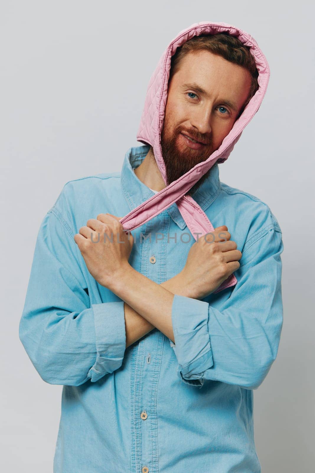 Funny man in a pink hat portrait on a light gray background. Smile and positive emotions. High quality photo