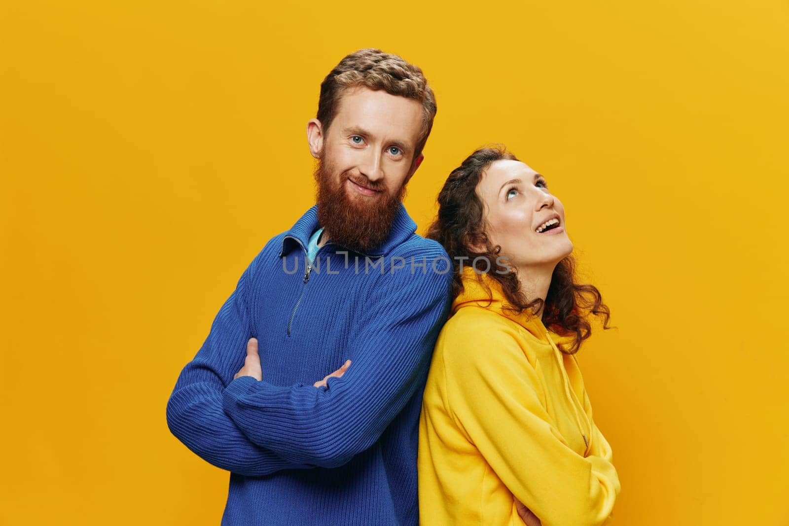 Man and woman couple smiling cheerfully and crooked with glasses, on yellow background, symbols signs and hand gestures, family shoot, newlyweds. High quality photo