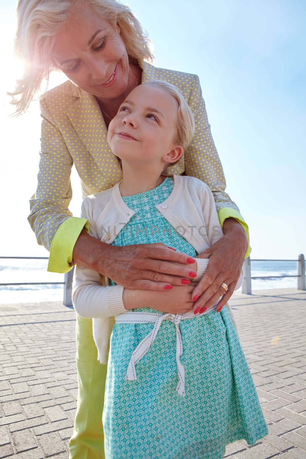 Grandma is my hero. a grandmother and her granddaughter spending some time outdoors. by YuriArcurs