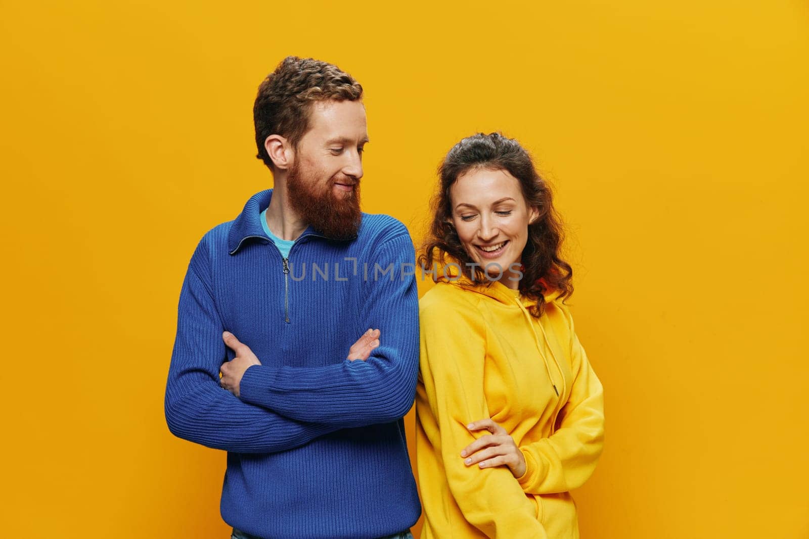 Man and woman couple smiling cheerfully and crooked with glasses, on yellow background, symbols signs and hand gestures, family shoot, newlyweds. by SHOTPRIME