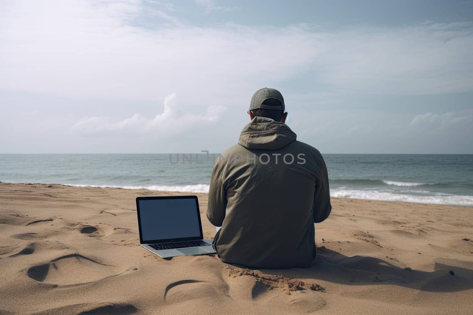 Young man with laptop computer on a beach. Freelance work concept.