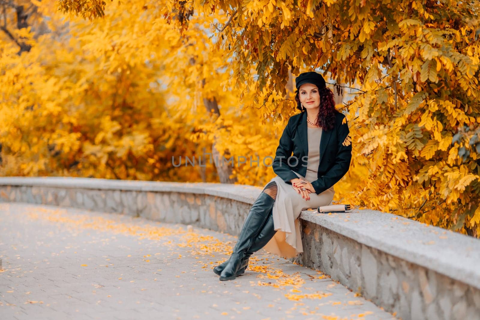 A woman walks outdoors in autumn, enjoys the autumn weather