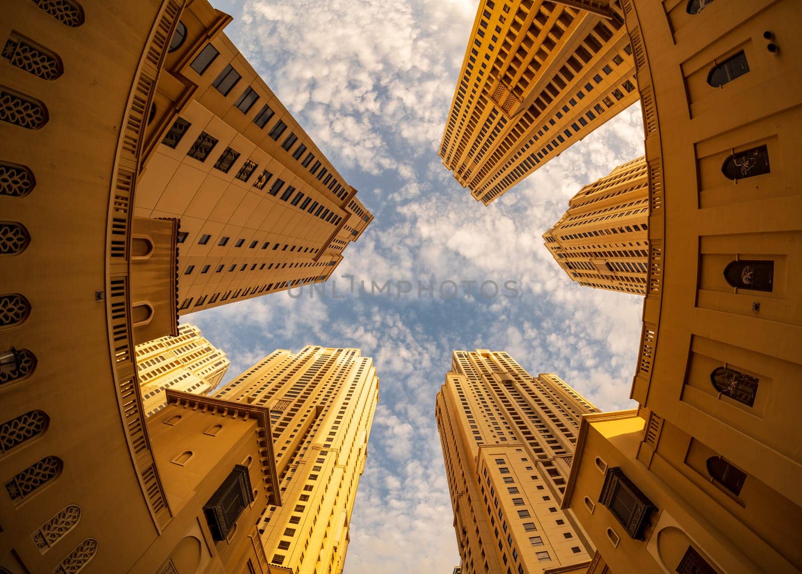 View up to sky with fisheye lens of the hotel towers at JBR Beach in Dubai UAE