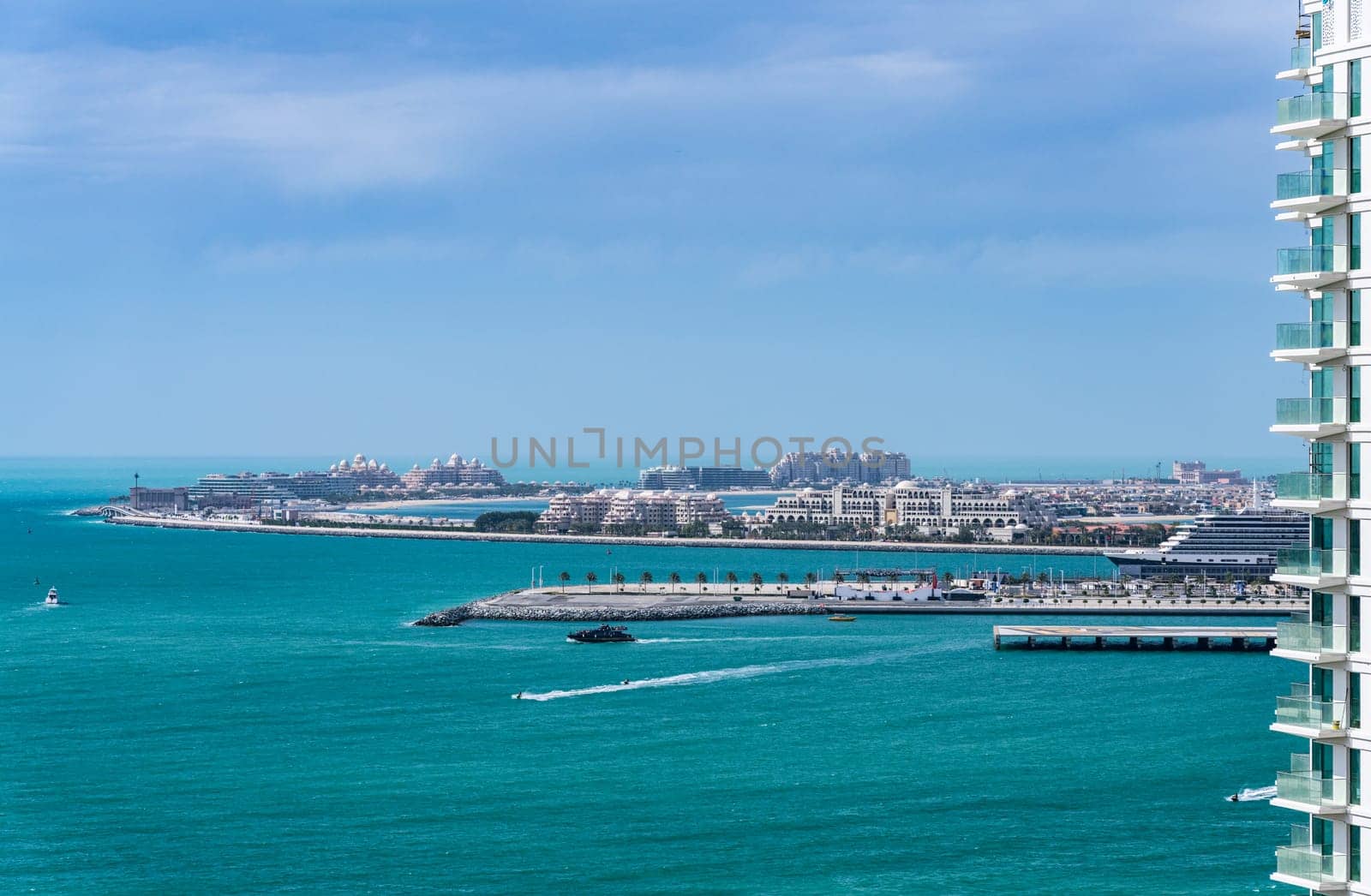 Cruise ship in port alongside the island of Palm Jumeirah off JBR beach in Dubai