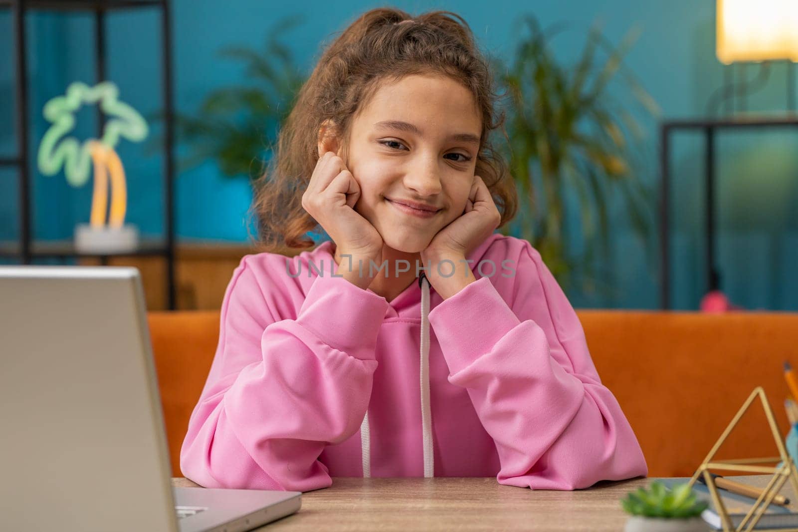 Close-up portrait of happy calm Caucasian preteen school girl smiling friendly, glad expression looking at camera dreaming resting, relaxation feel satisfied good news. Young child kid at home room