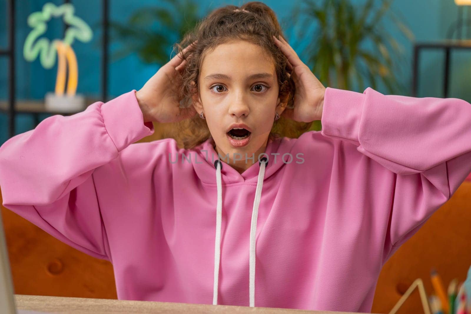 Portrait of sad scared Caucasian preteen school girl holding her head, failed exam, mistake. Problem, break up, depressed feeling bad annoyed, burnout. Frustrated worried child, kid at home workplace