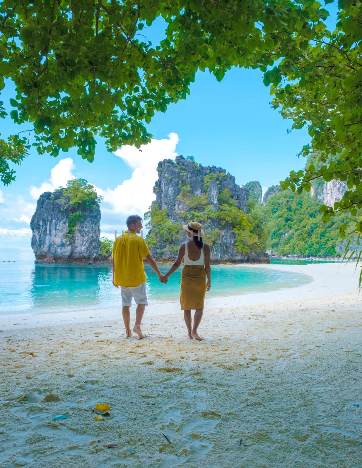 Koh Hong Island Krabi Thailand, couple of men and woman on the beach of Koh Hong by fokkebok