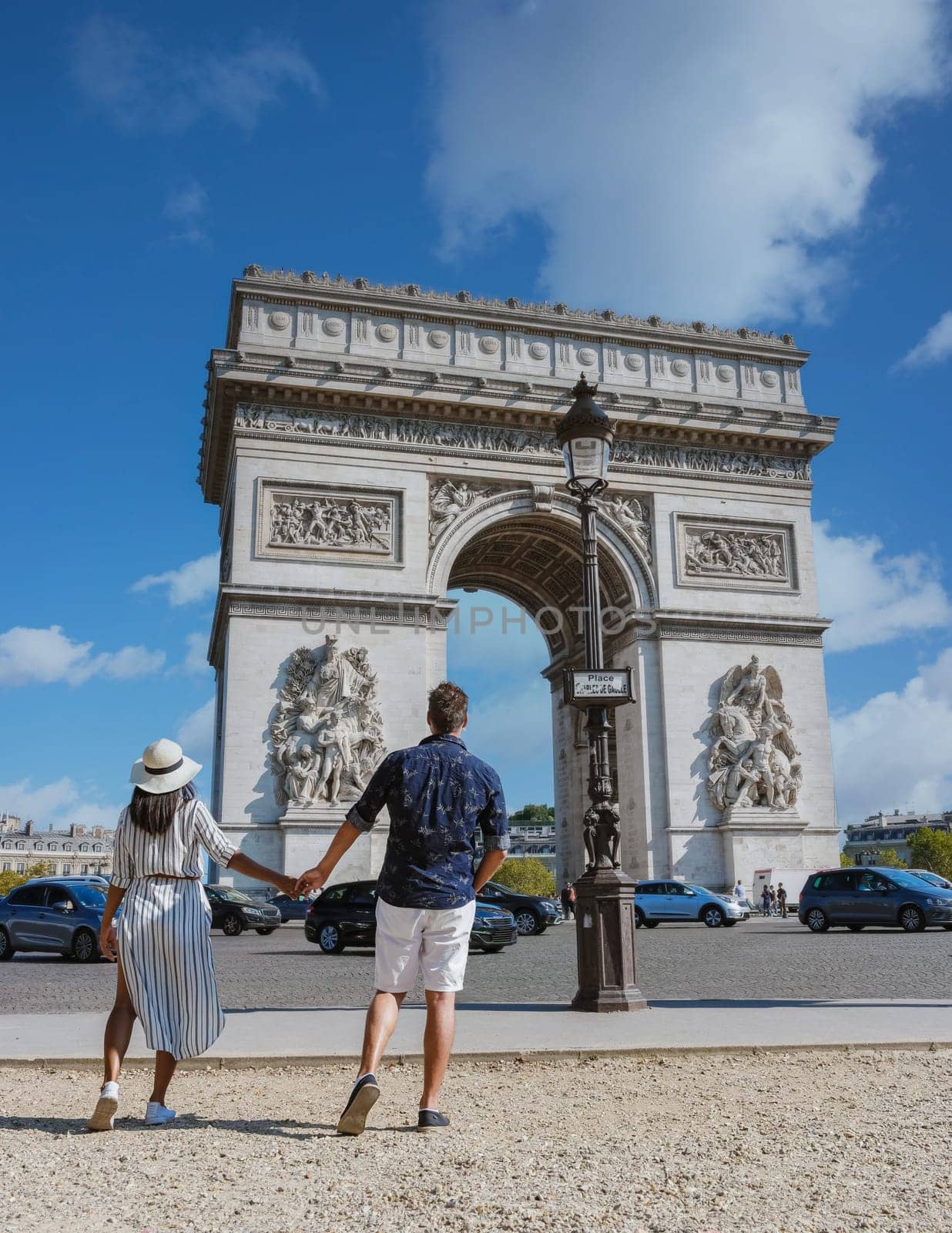 Couple on a citytrip in Paris visiting Avenue des Champs-Elysees Paris France Arc De Triomphe by fokkebok