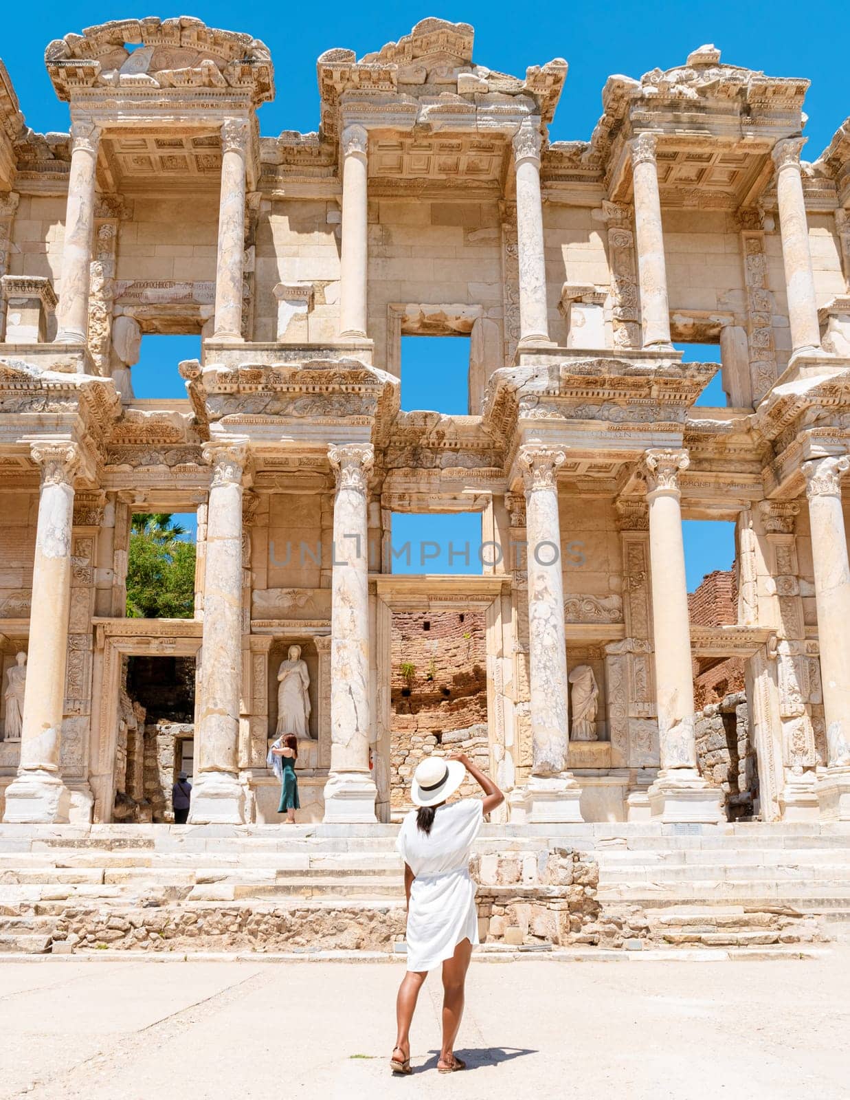 Ephesus ruins, Turkey, beautiful sunny day between the ruins of Ephesus Turkey. Asian women with a hat visit Ephesus Unesco heritage
