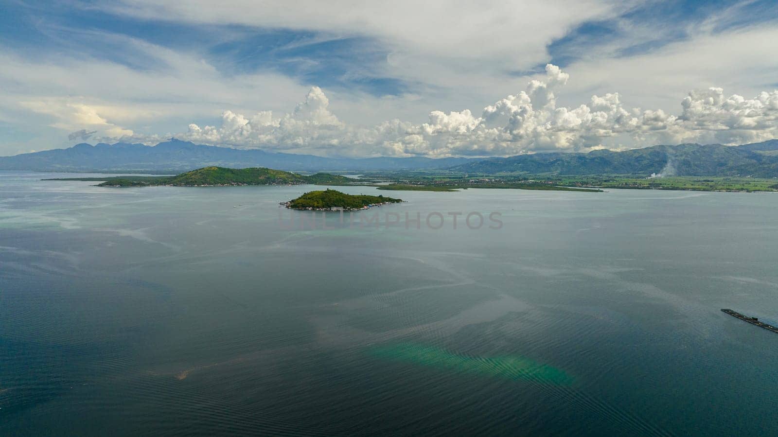 Aerial drone of coast of Negros Island with farmland and town. Negros, Philippines.