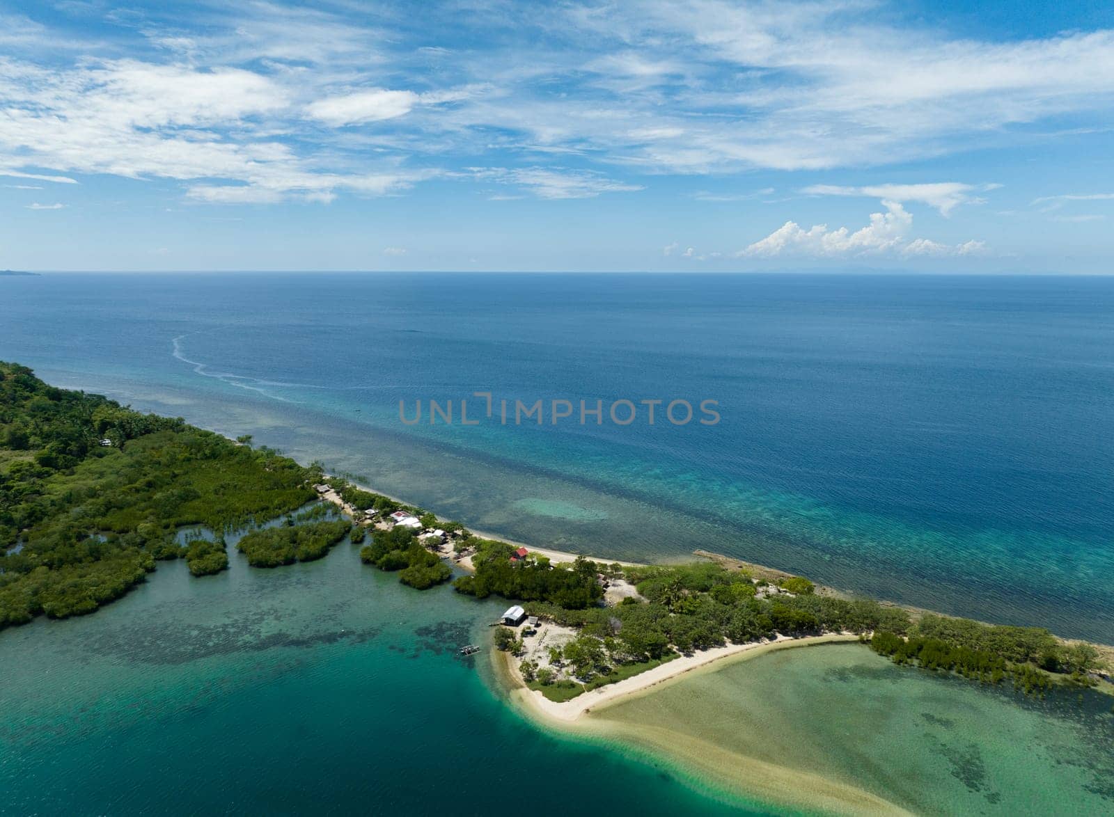 Top view of tropical island coastline and blue sea. Ocean and blue sky. Turtle Islands, Negros, Philippines