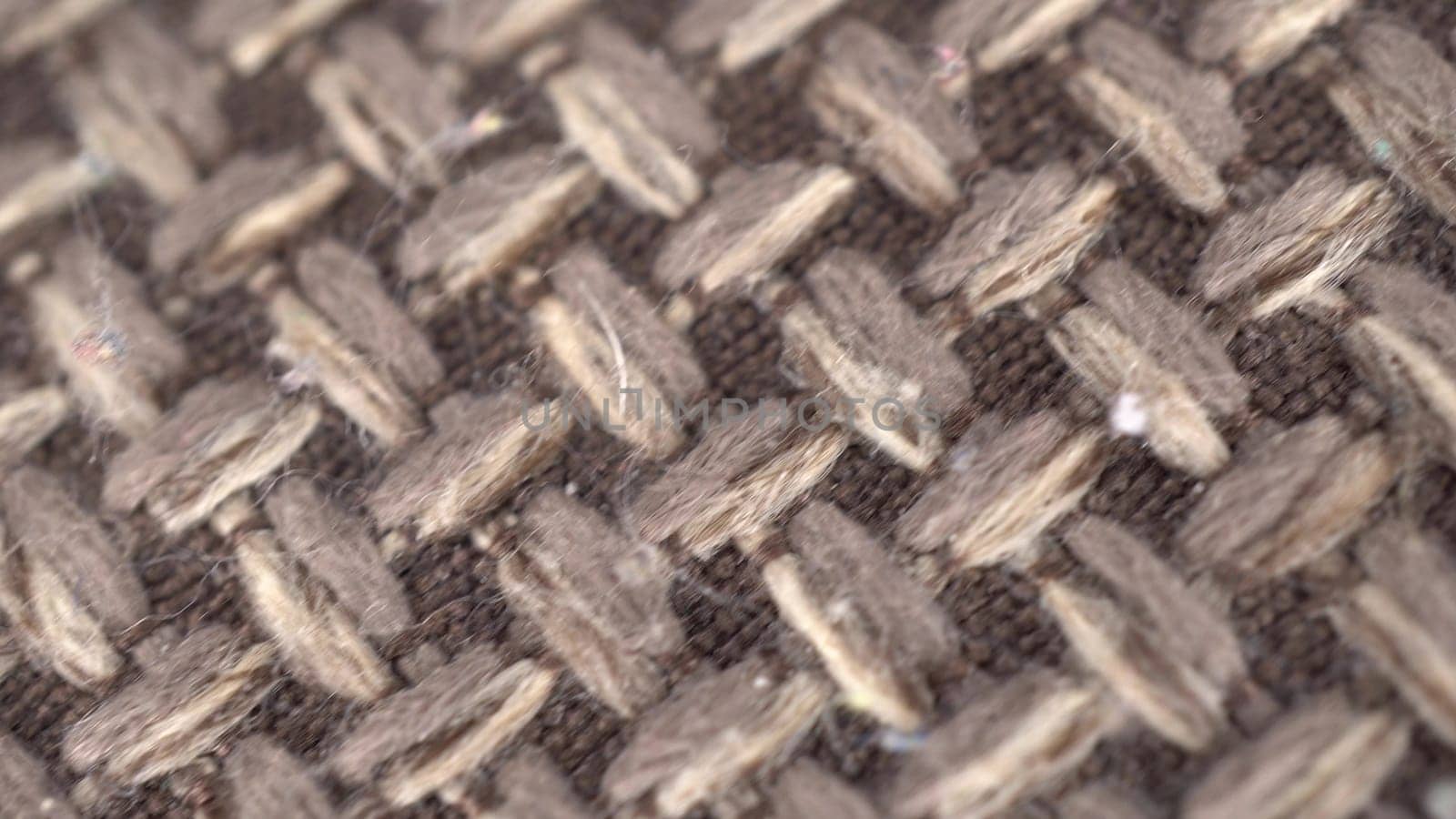 Wicker gray fabric macro. The camera shoots a plaid in the motion of a dolly. 4k
