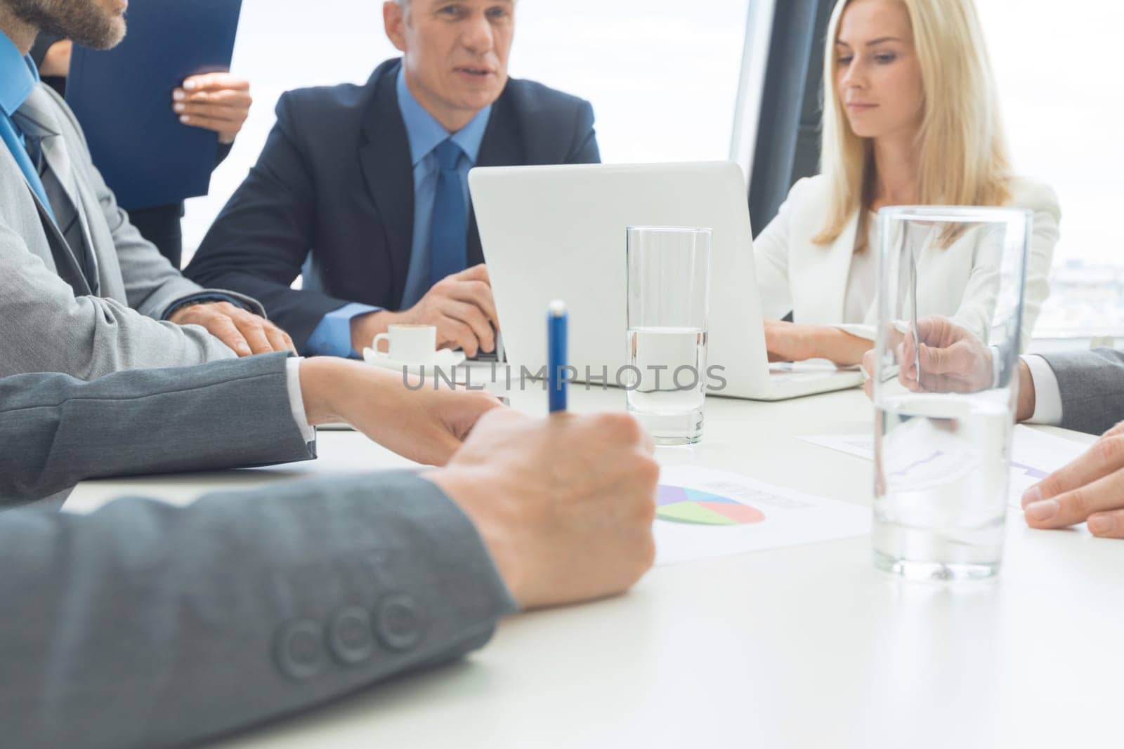 Business people team diverse coworkers, executive managers group at meeting. Professional businesspeople working together on research plan in boardroom.