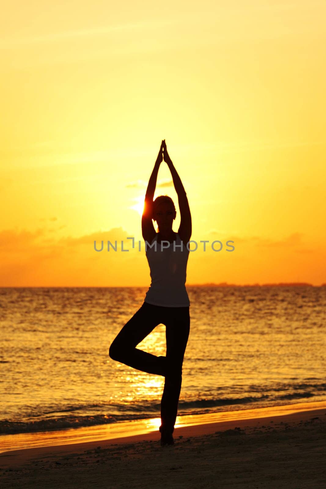 sunset yoga woman on sea coast