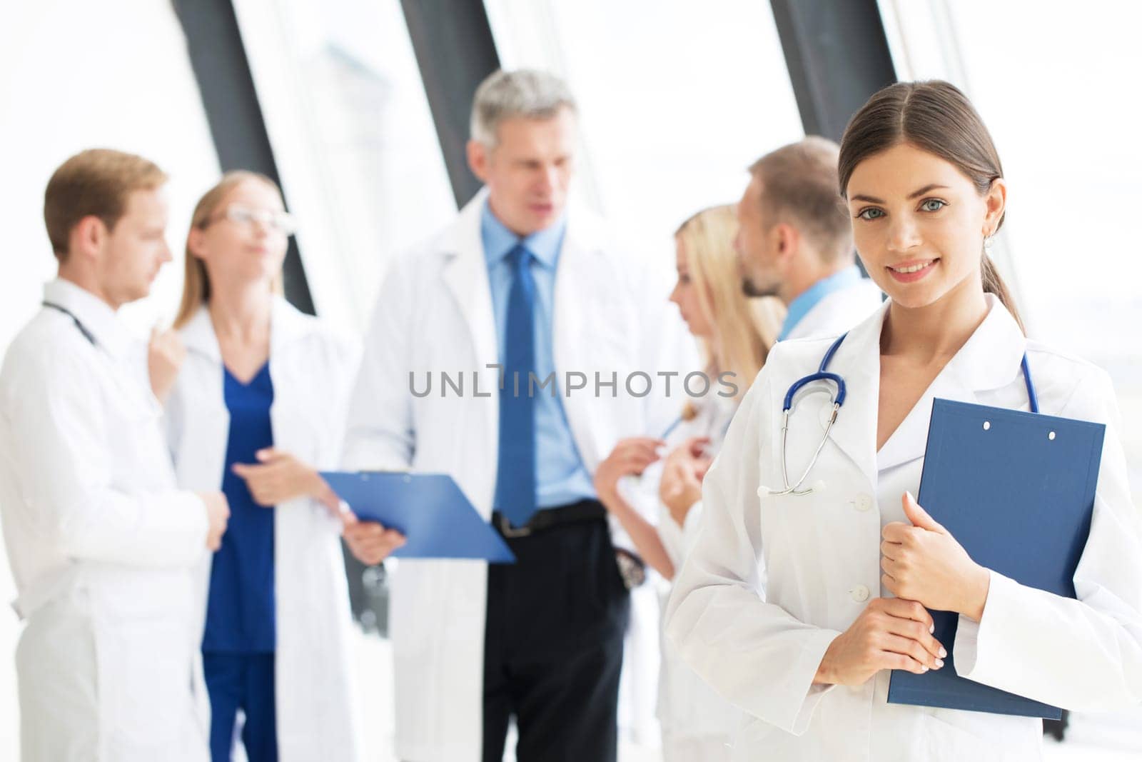 Portrait of group of smiling hospital colleagues standing together