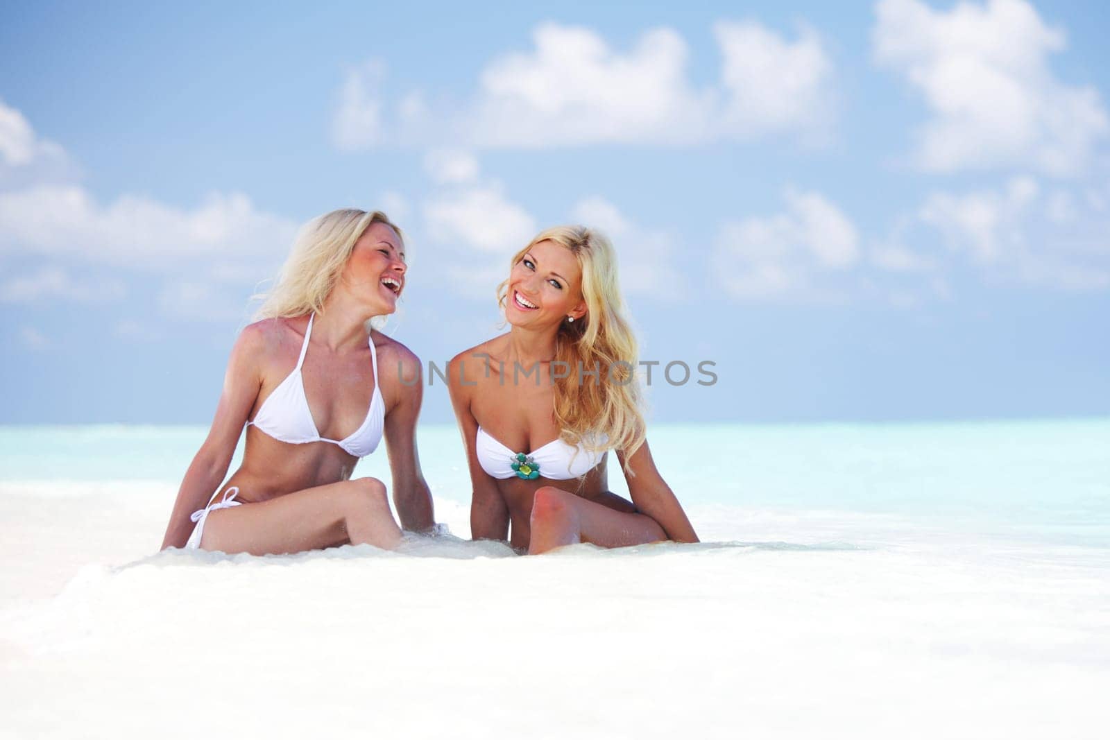 girls sitting on ocean coast by Yellowj