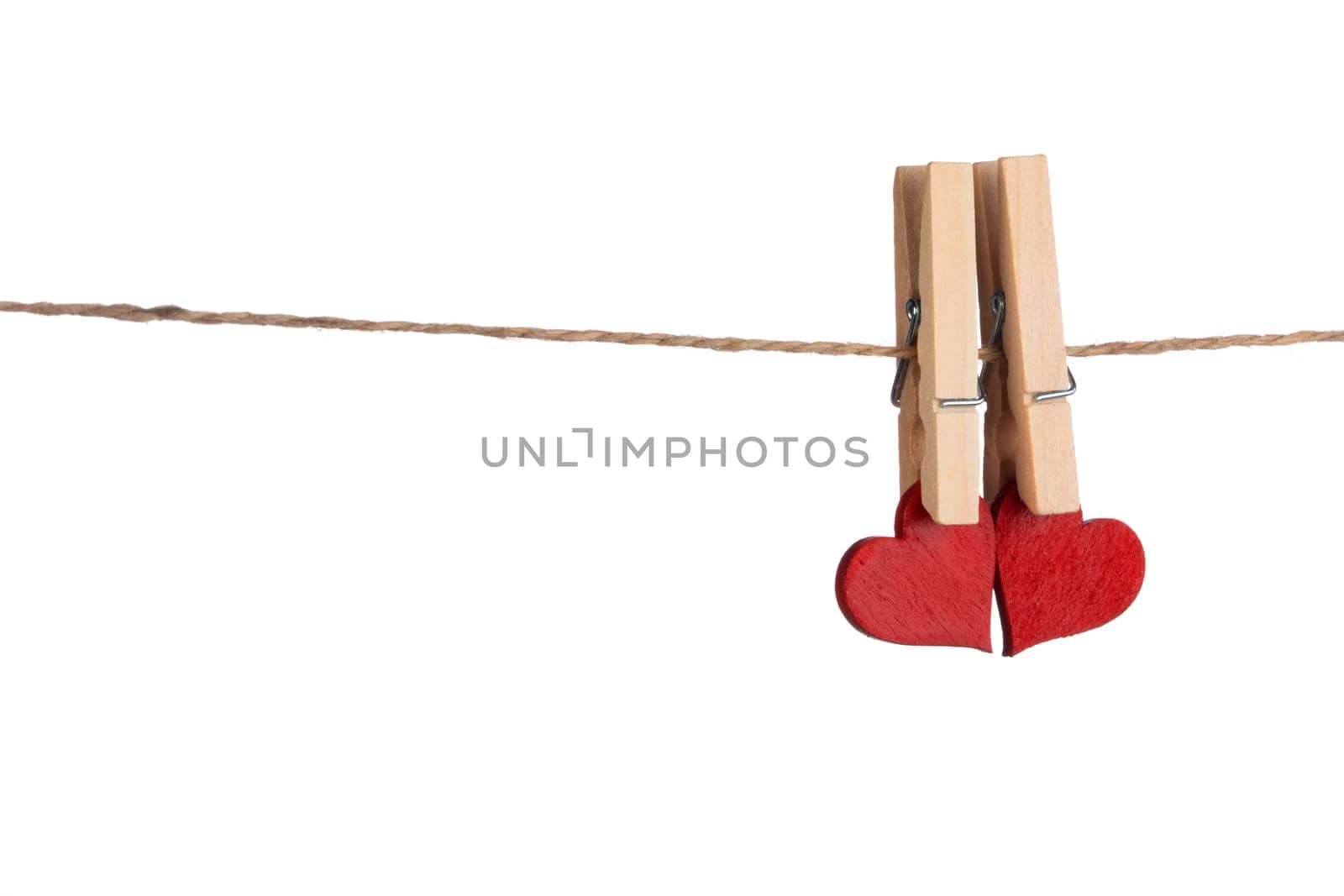 Clothes pegs and two red hearts on rope isolated on white background Valentines day concept