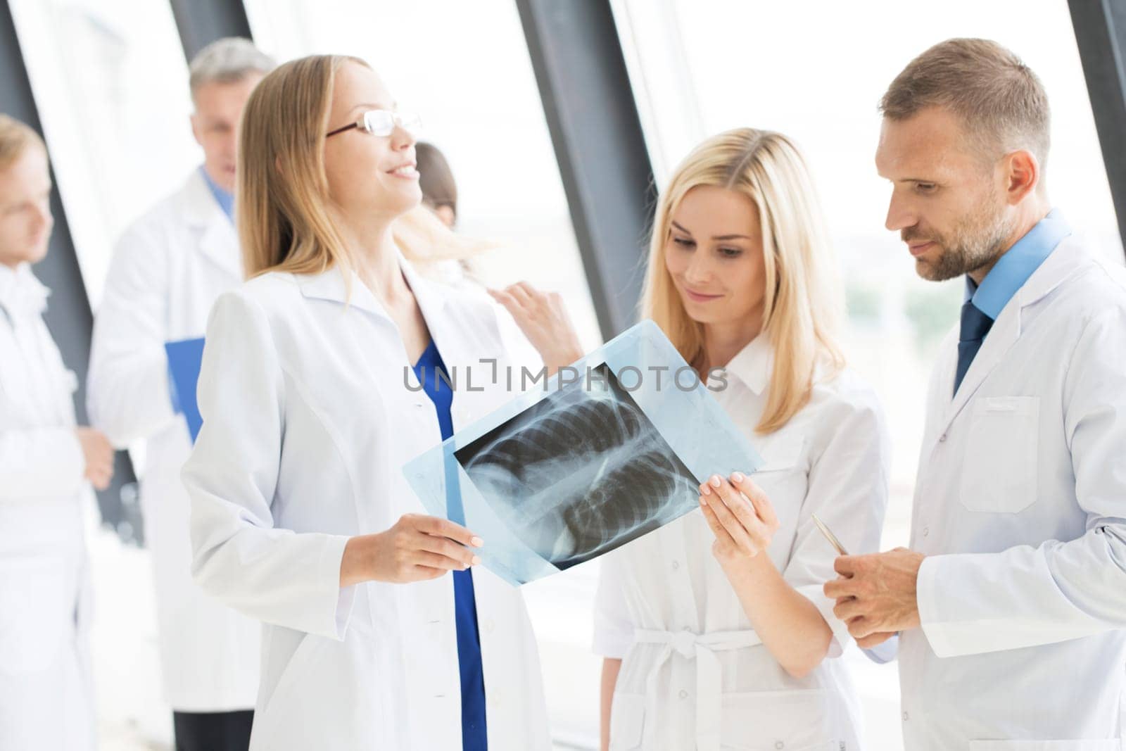 Group of doctors looking at x-ray by Yellowj