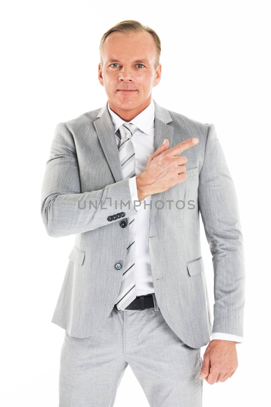 Portrait of smiling mature businessman wearing gray suit pointing aside isolated on white background