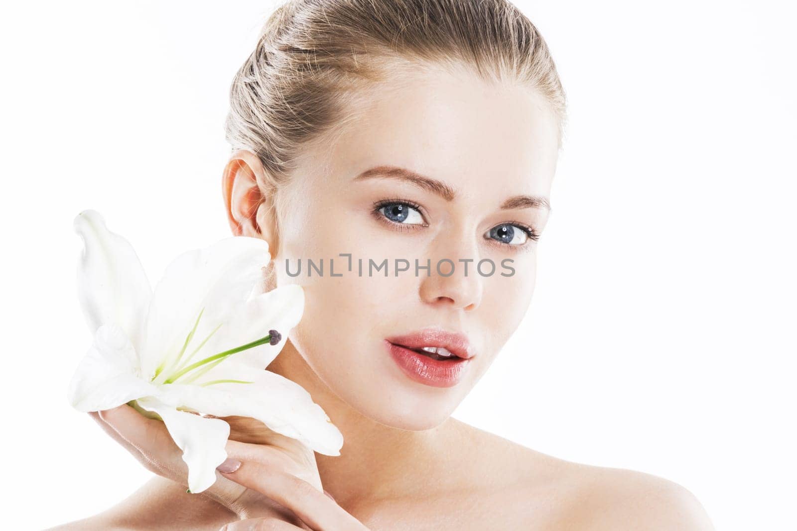 Beautiful young perfect woman holding white lily flower near the face - studio isolated on white background, copy space for text