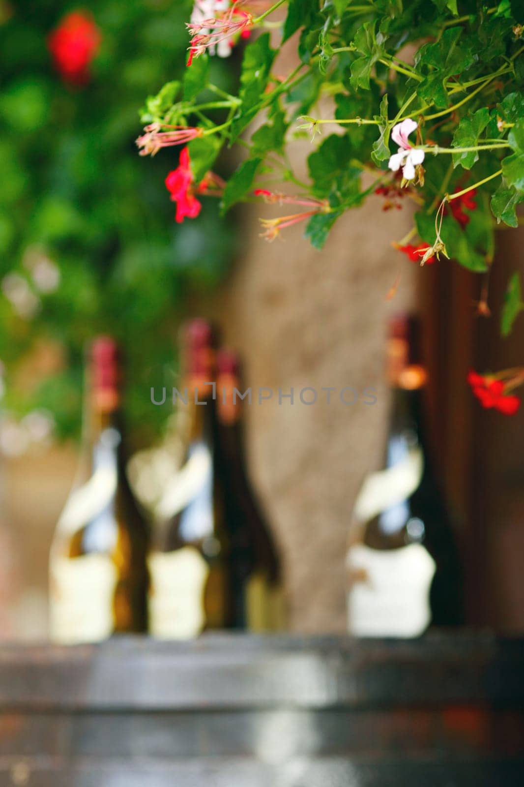 Wine bottles on wodden barrel, winemaking concept