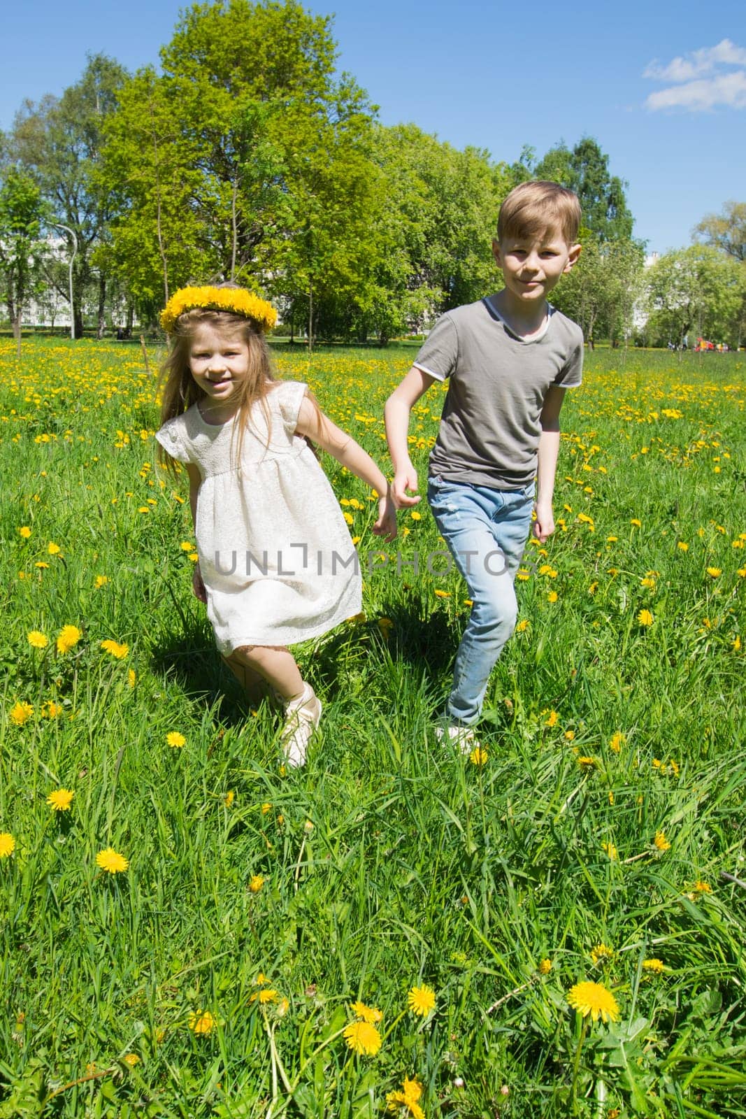 Happy children run on meadow by Yellowj