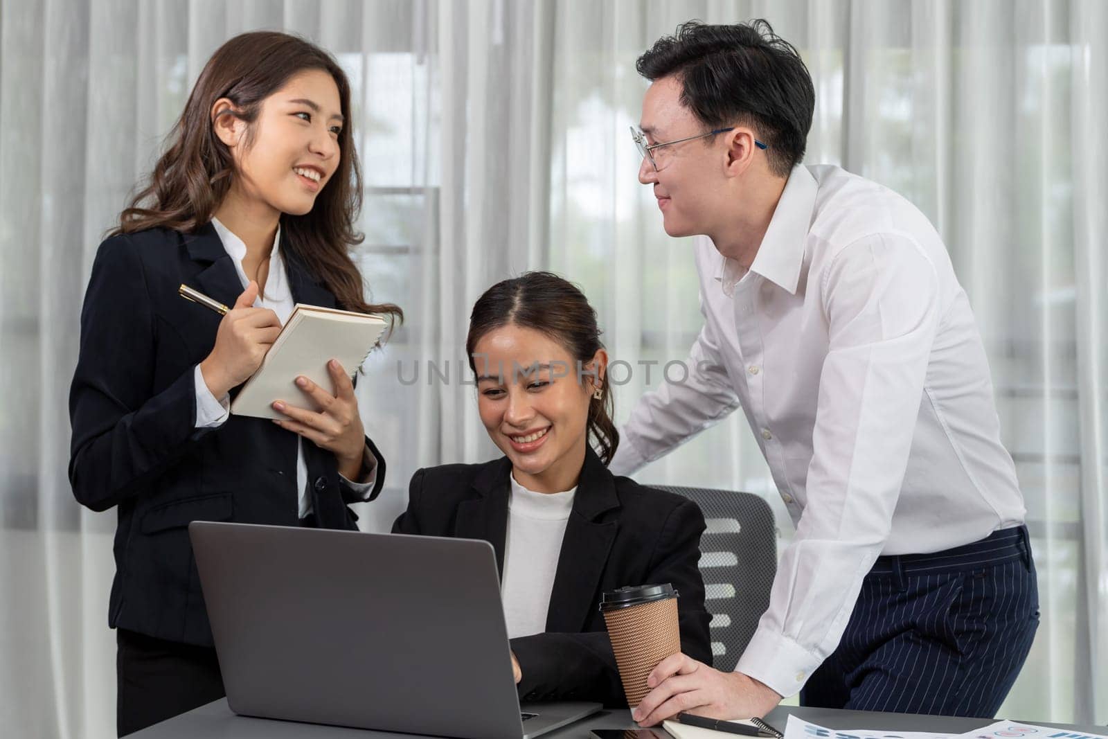 Harmony in office concept as business people analyzing dashboard paper together in workplace. Young colleagues give ideas at manager desk for discussion or strategy planning about project.