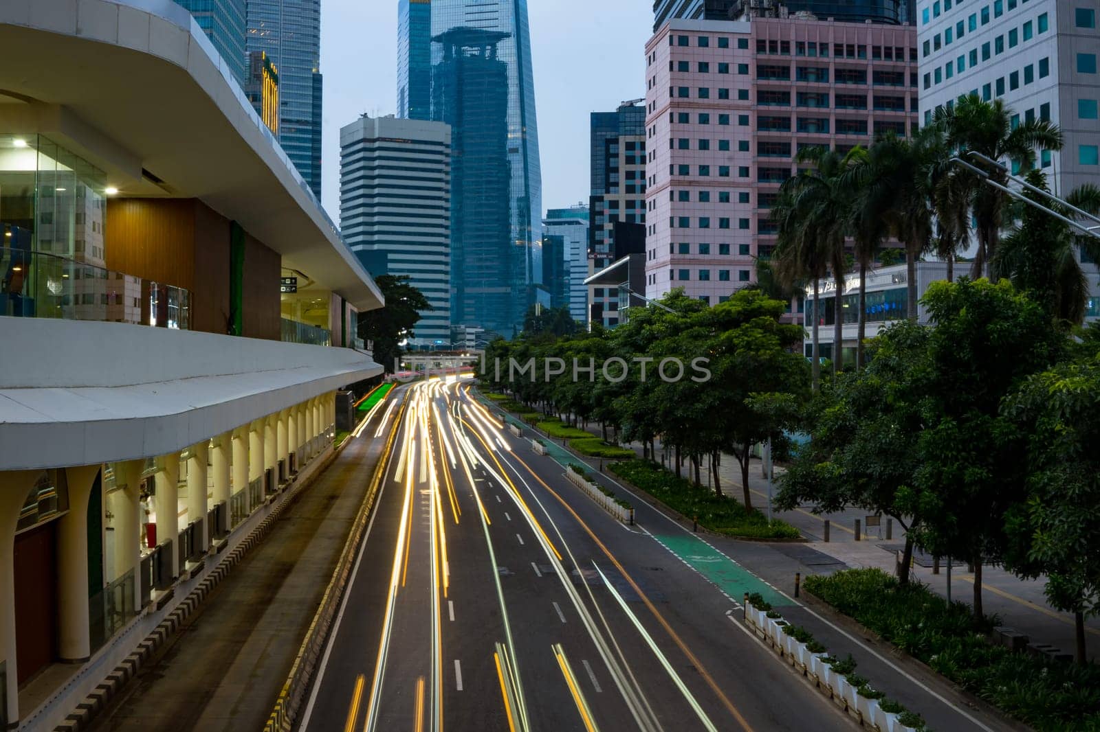 Jakarta, Indonesia. April 23, 2023. The city light trails against the buildings. On Jalan Jenderal Sudirman. Jakarta. Long Exposure Photography. Motion blur.