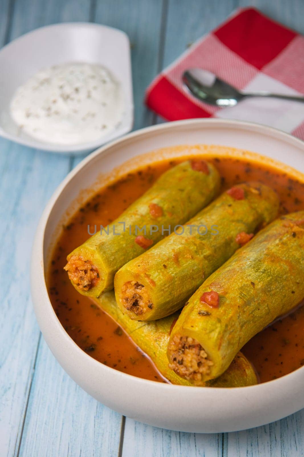 Recipe of stuffed courgette with tomato sauce, Lebanese style, Kouca Mehchi bi Banadoura, with Greek yogurt. High quality photo