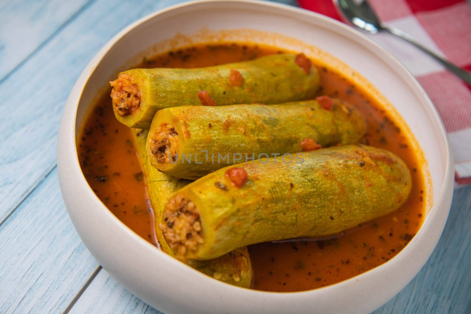 Recipe of stuffed courgette with tomato sauce, Lebanese style, Kouca Mehchi bi Banadoura, with Greek yogurt. High quality photo