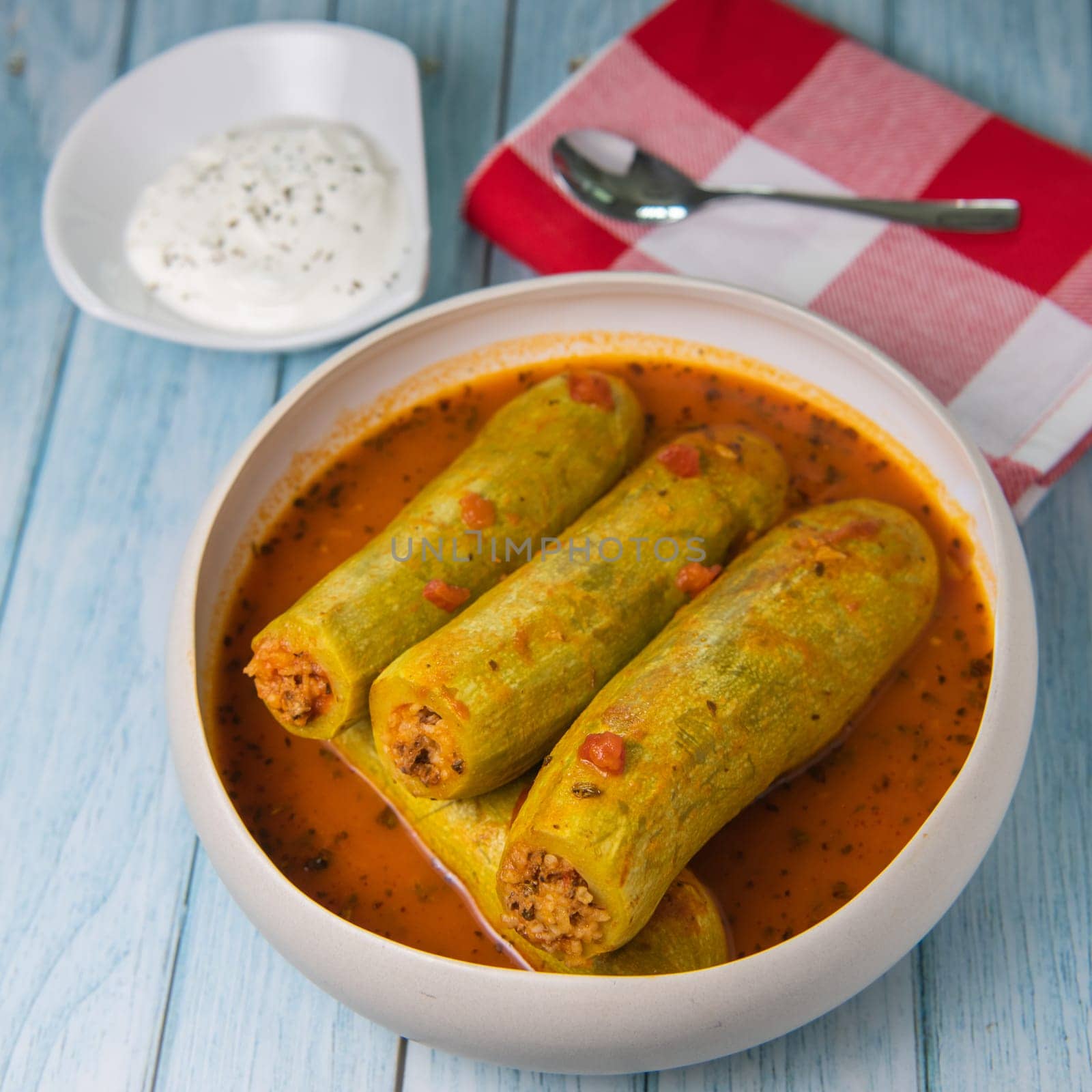 Recipe of stuffed courgette with tomato sauce, Lebanese style, Kouca Mehchi bi Banadoura, with Greek yogurt. High quality photo
