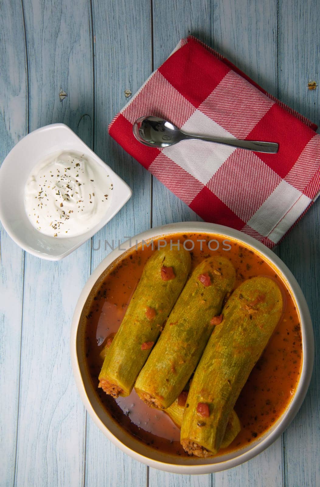 Recipe of stuffed courgette with tomato sauce, Lebanese style, Kouca Mehchi bi Banadoura, with Greek yogurt. High quality photo