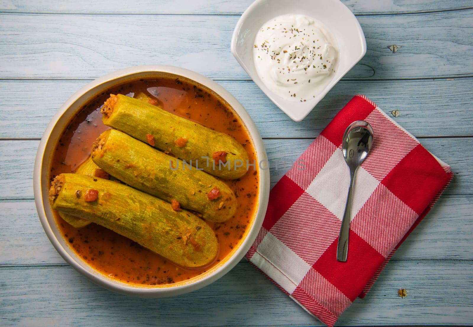 Recipe of stuffed courgette with tomato sauce, Lebanese style, Kouca Mehchi bi Banadoura, with Greek yogurt. High quality photo