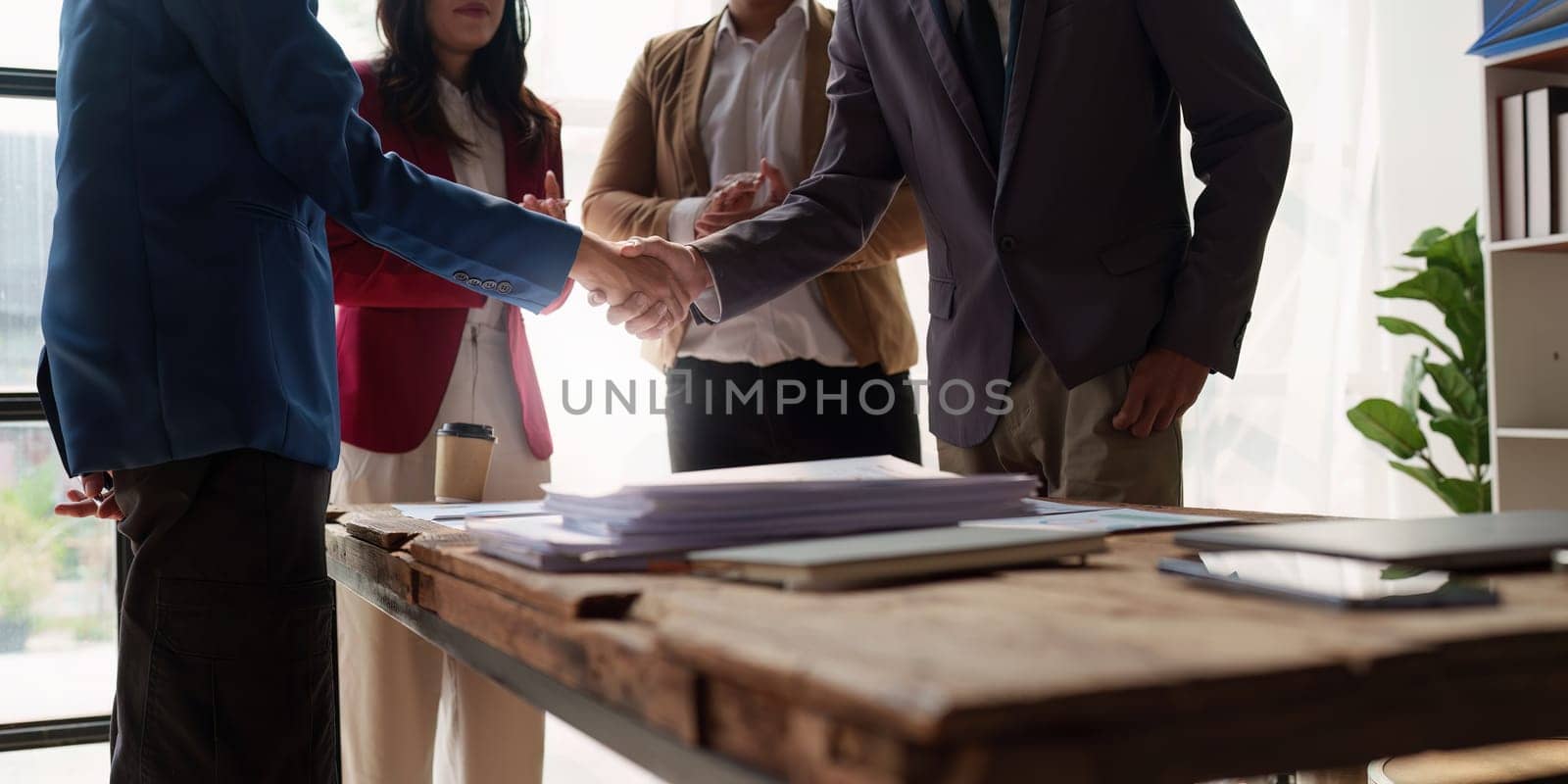 Business partnership meeting concept. Image business people handshake. Successful businessmen handshaking after good deal. Group support concept by itchaznong