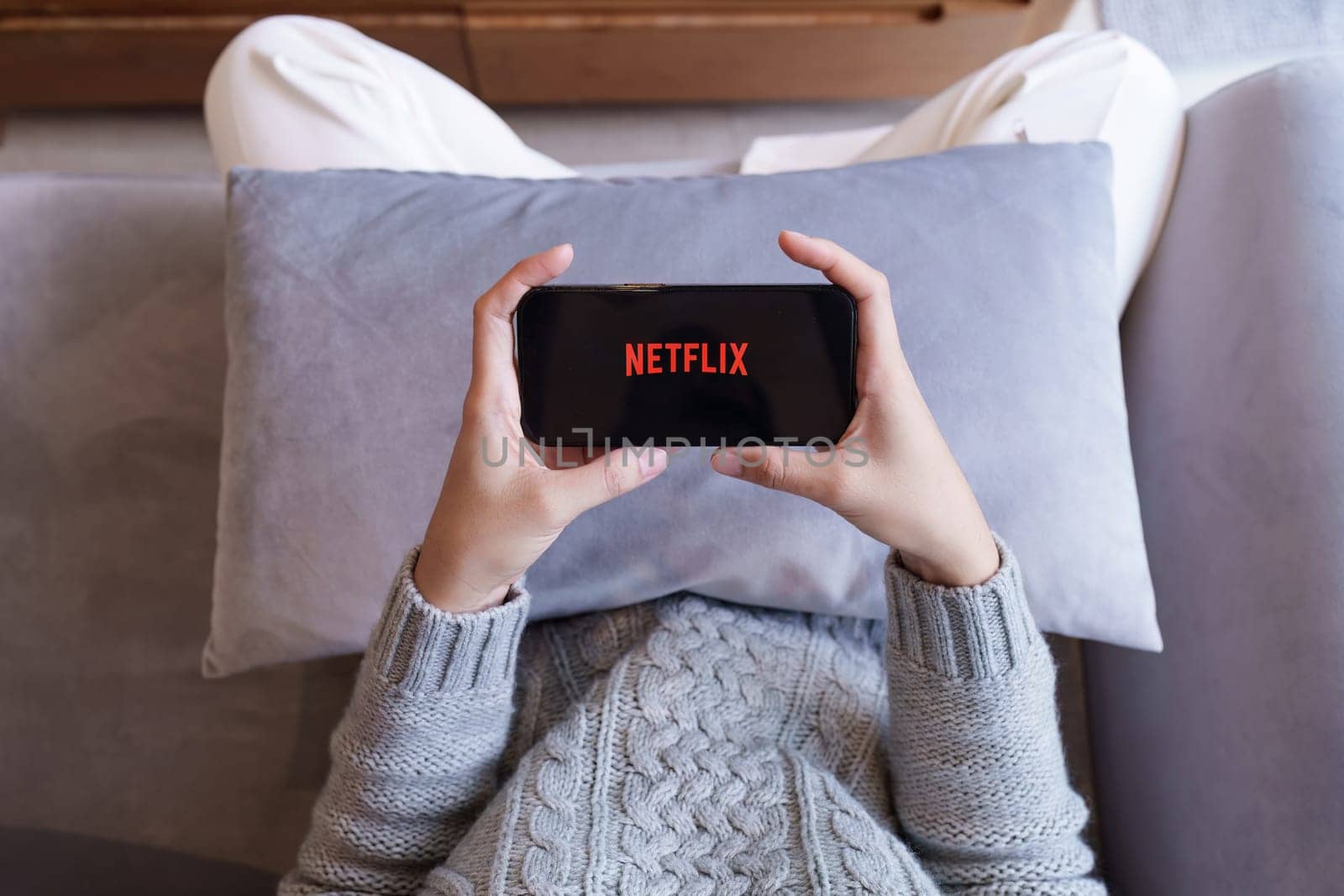 CHIANG MAI, THAILAND APR 21, 2023: Netflix logo on iPhone screen. Netflix is an international leading subscription service for watching TV episodes and movies by itchaznong