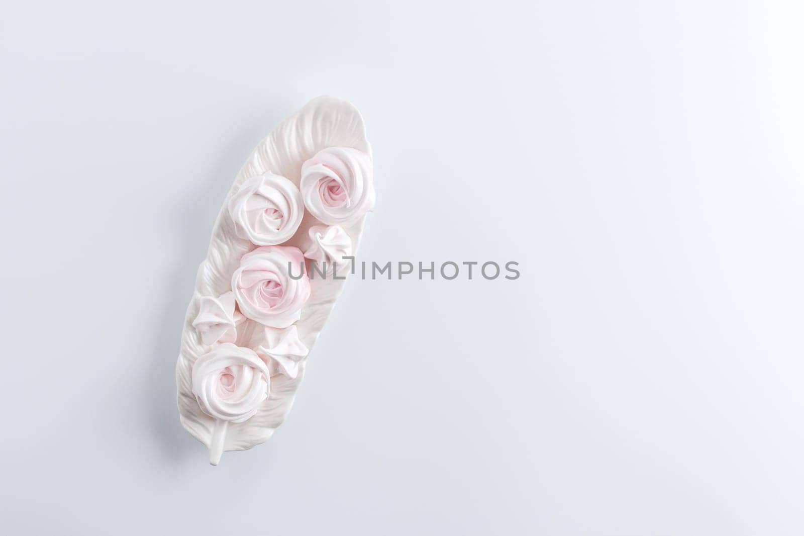 Meringue. Light dessert of whipped egg whites on a white background. copy space by lara29