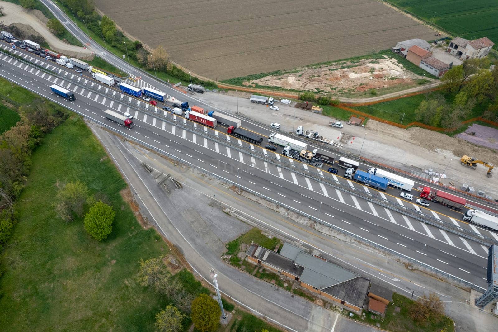 Motorway traffic jam transport cargo trucks and cars stop wait by verbano
