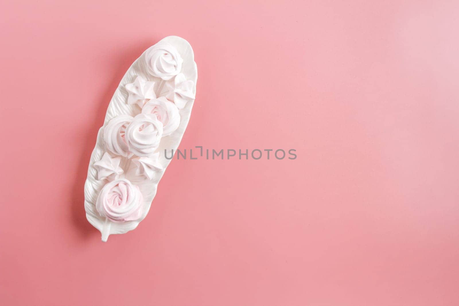 Meringue. Light dessert of whipped egg whites on a pink background. copy space by lara29