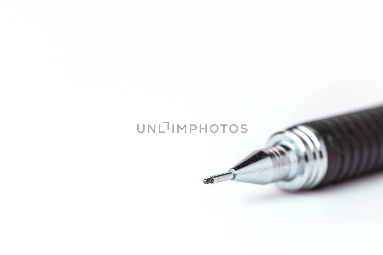 Closeup image of the pointed end part of a mechanical pencil on white background for the concept of office and school stationary.